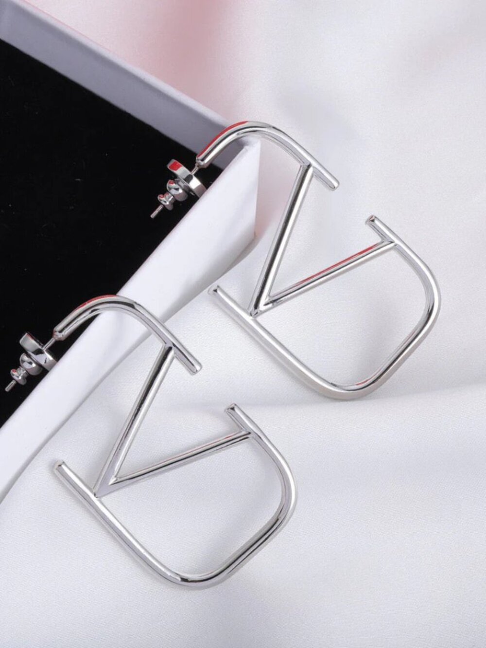 "Valentino" V logo earrings in silver tone